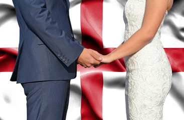 Husband and Wife holding hands - Conceptual photograph of marriage in England