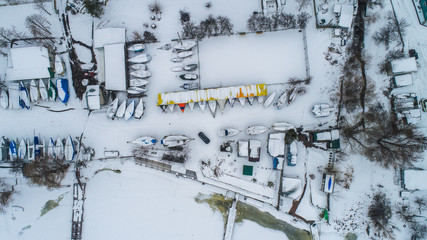 winter ständig sail boats on ground , lot of snow , top view , drone shoot 