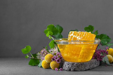 Honeycombs and floral honey with wildflowers. Photo with negative space for text.