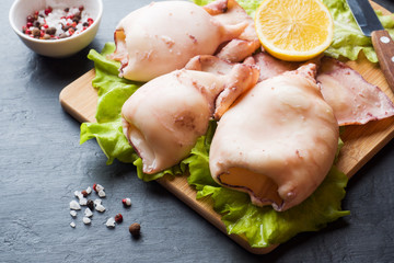 Boiled whole squid on a plate. Seafood.