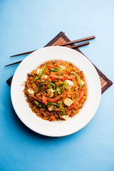 Schezwan paneer fried rice with Szechuan sauce and cottage cheese cubes. served in a bowl or plate or pan. selective focus
