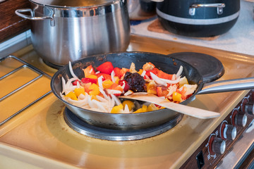 Wooden flipper frying chili sauce, vegetable,herb and oil