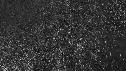 Background texture of shiny black wrinkled foil
