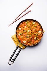 Schezwan paneer fried rice with Szechuan sauce and cottage cheese cubes. served in a bowl or plate or pan. selective focus