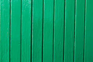 Old wooden surface covered with green paint. Closeup.