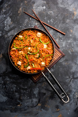 Schezwan paneer fried rice with Szechuan sauce and cottage cheese cubes. served in a bowl or plate...