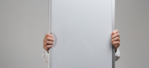 Men's hands holding clean magnetic Board isolated on white background