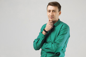 Portrait of a man in business clothes with a hand at face on white background