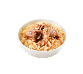 Pork ribs baked with sauerkraut in a bowl isolated on white background with clipping path