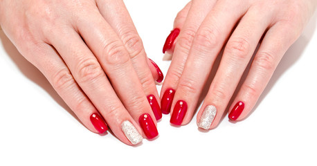 Woman's nails with beautiful red manicure fashion design with gems isolated