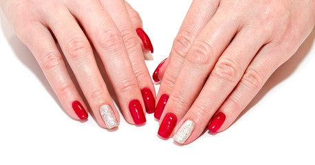 Fototapeta premium Woman's nails with beautiful red manicure fashion design with gems isolated