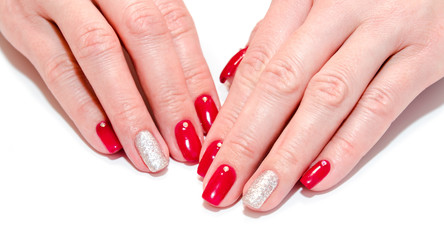 Fototapeta premium Woman's nails with beautiful red manicure fashion design with gems isolated