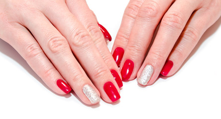Woman's nails with beautiful red manicure fashion design with gems isolated