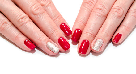 Woman's nails with beautiful red manicure fashion design with gems isolated