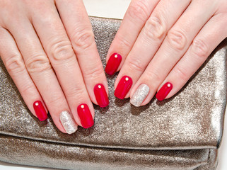 Woman's nails with beautiful red manicure fashion design