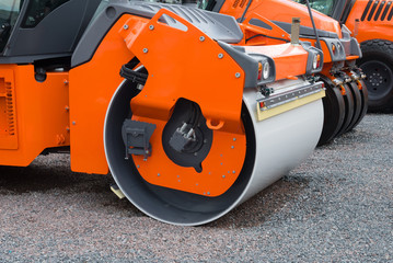 Closeup of new asphalt rollers in a row. Road machinery