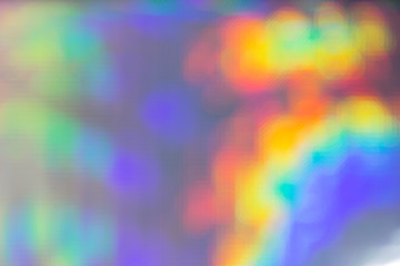 Abstract festive holographic multicolored purple magic rainbow background of different shade.