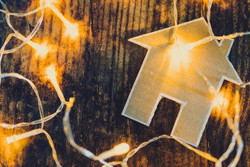 miniature house made of cardboard with fairy lights around it