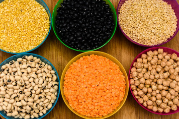 variety of legumes such as chick peas, lentils and mung beans in bowls