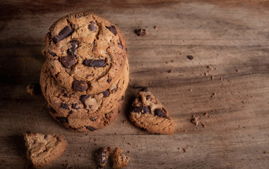  Dark Chocolate chip cookies with chocolate pieces on wooden  background. Copyspace. Macro image