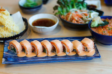 Japanese sushi rolls with cream cheese, salmon decorated.