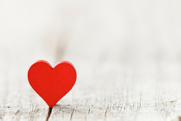 Red heart on wooden background