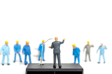 Miniature people : A politician speaking to the people during an election rally 