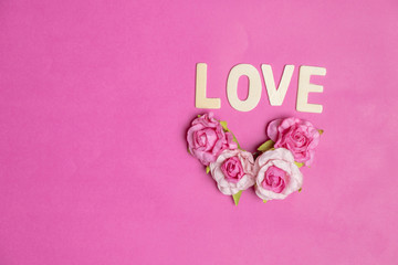 word LOVE in red hearts on pink background, Love icon, valentine's day, relationships concept with copy space