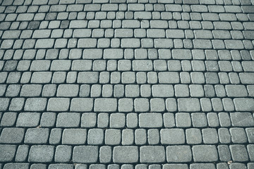 Cobblestone background, focus on the front, color toning applied.