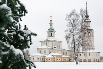 Russian orthodox church, the bell tower and christmas tree in the winter among the white snow. Veliky Ustyug, Russia