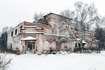 View of the old dilapidated russian church in the winter in the snow