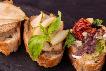 Bruschetta with a liver duck and slices of pear