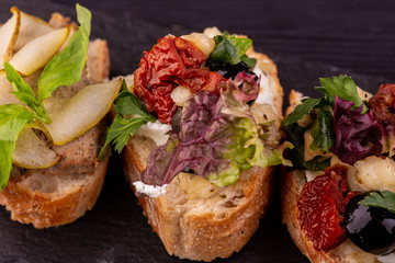 Bruschetta with dried tomatoes and lettuce leaves