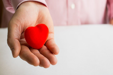 red heart in man's hand with copy space, Close up