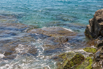 Rocks in the middle of crystal clear sea water