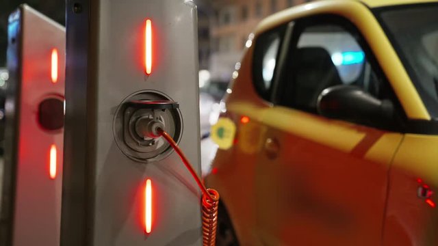 The charge indicators on the stations. Charging of electric car. Eco energy, transport and power supply. 4K.