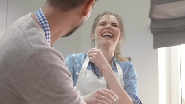 Young couple enjoying in kitchen