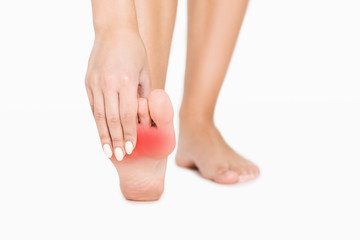 Pain in foot. Woman touching red hurt zone