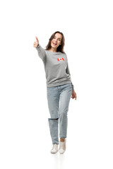 Obraz premium woman with canadian flag badge showing thumb up sign isolated on white