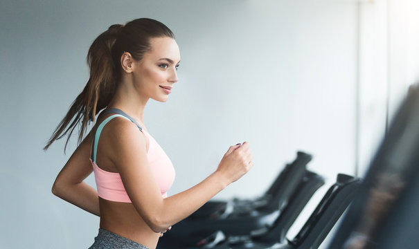 Woman doing cardio training on treadmill in gym