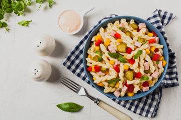 Italian fusilli pasta in a salad with ham and vegetables.