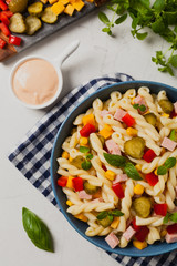 Italian fusilli pasta in a salad with ham and vegetables.