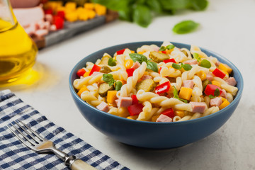 Italian fusilli pasta in a salad with ham and vegetables.