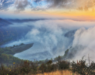 foggy canyon of a picturesque river. foggy autumn morning