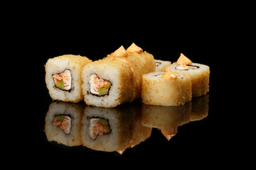 various sushi, rolls on a black background with reflection. especially for cafes and restaurants