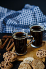 Two cups of coffee and chocolate and oatmeal cookies