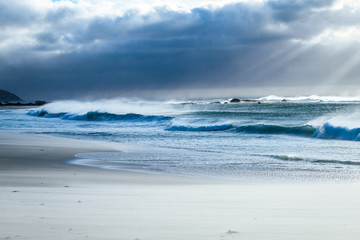 Waves crashing on the beach on a summer evening at Camps bay in Cape Town, South Africa