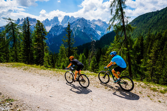 Mountain cycling couple with bikes on track, Cortina d'Ampezzo, Dolomites, Italy © Gorilla