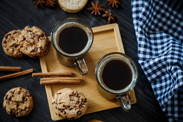 Two cups of coffee and chocolate and oatmeal cookies