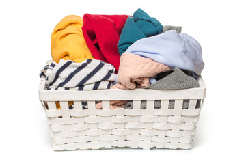 Clothes in a laundry wooden basket isolated on white background.